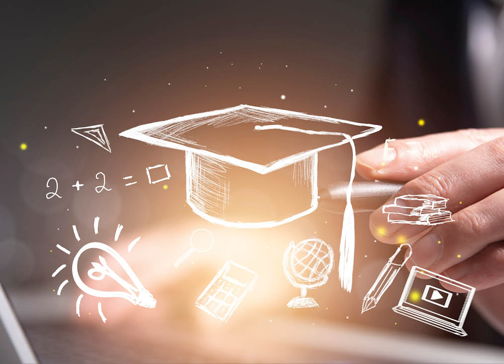 close view of man hands using laptop and graduation cap