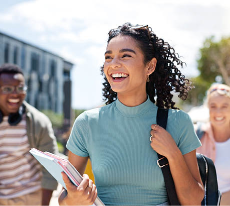 Walking, happy and girl with friends at university for learning, bonding and talking with fun. People, school and group of gen z students commuting outdoor ready for education at college campus.