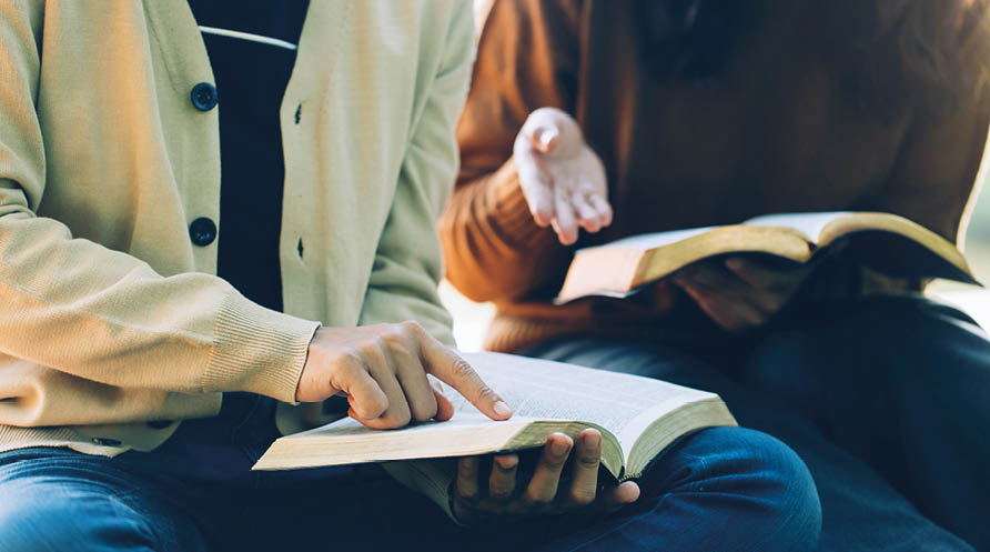 Christian Bible Study Concepts. Christian friends read and study the bible together in the park. followers are studying the word of God in churches. sharing the gospel with a friend. Education