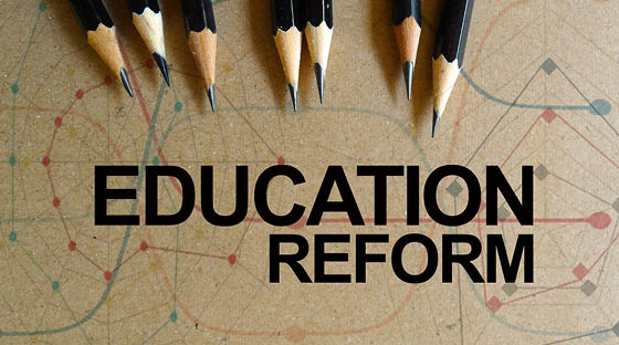 Word text Education Reform memo written on a brown craft paper as background with pencils