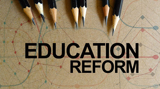 Word text Education Reform memo written on a brown craft paper as background with pencils